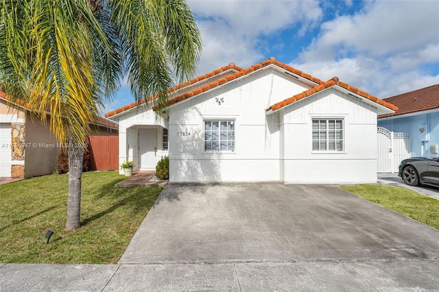 mediterranean / spanish home with a garage and a front yard