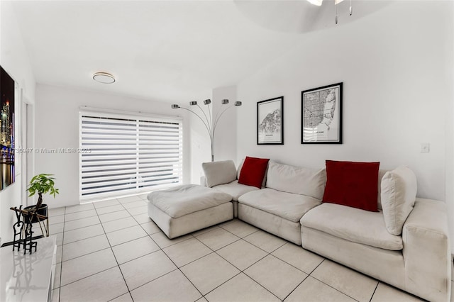 tiled living room with ceiling fan