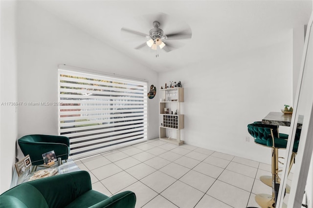 sitting room with light tile patterned floors, vaulted ceiling, and ceiling fan