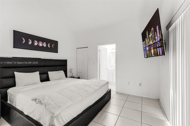 tiled bedroom featuring ensuite bath