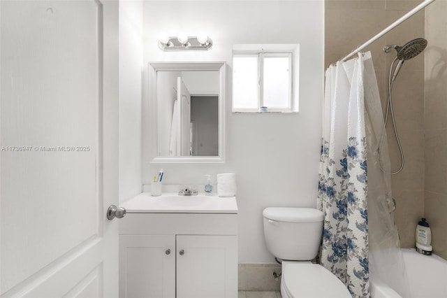 full bathroom with vanity, shower / tub combo, and toilet