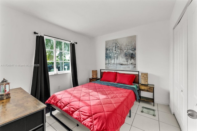 bedroom with light tile patterned floors and a closet