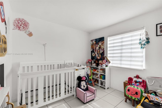 tiled bedroom featuring a nursery area