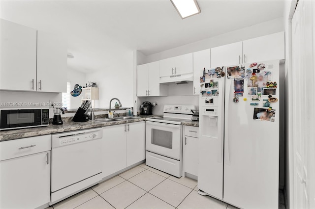 kitchen with white cabinetry, white appliances, and light tile patterned floors