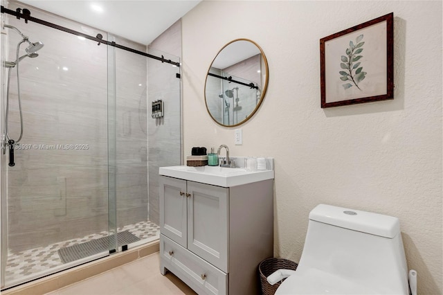 bathroom with vanity, toilet, and a shower with door