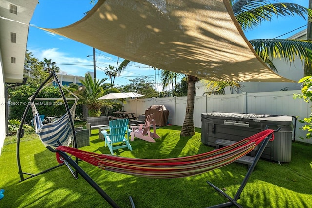 view of yard with a hot tub