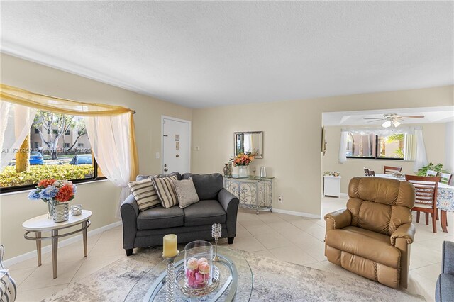 living room with plenty of natural light, a textured ceiling, and light tile patterned floors