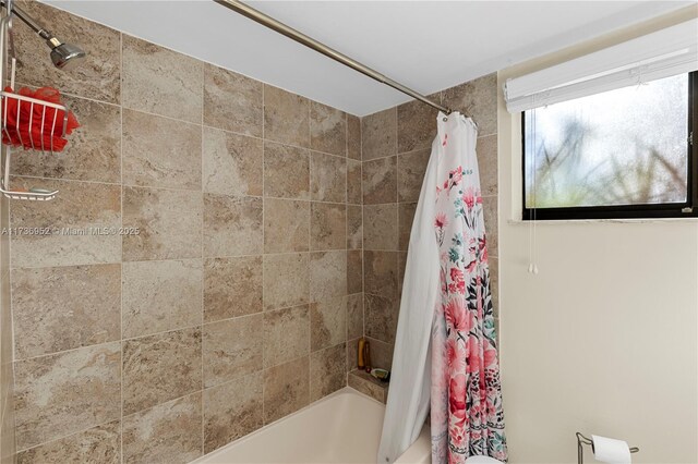 bathroom featuring shower / bathtub combination with curtain