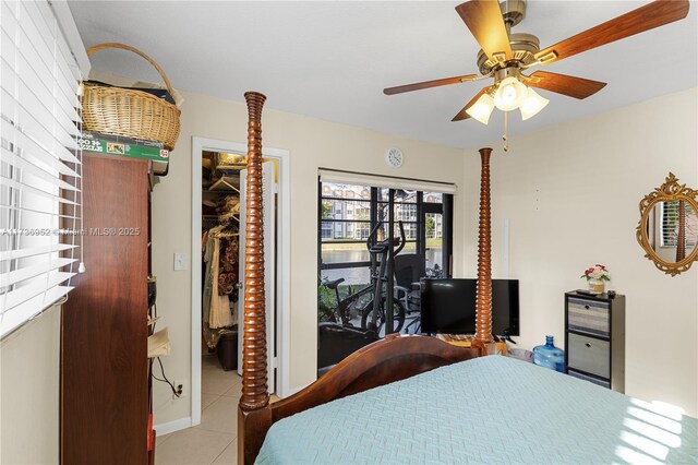 tiled dining room with ceiling fan and a tray ceiling