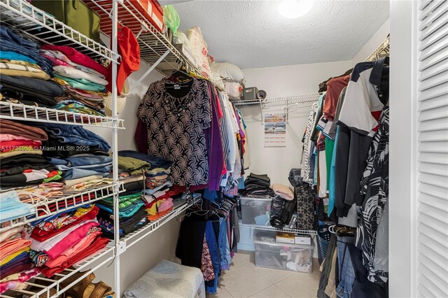 spacious closet with light tile patterned floors