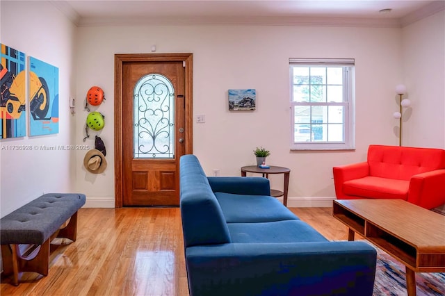 living room featuring ornamental molding and light hardwood / wood-style floors