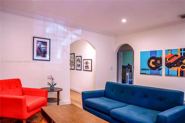 living room featuring crown molding and hardwood / wood-style floors