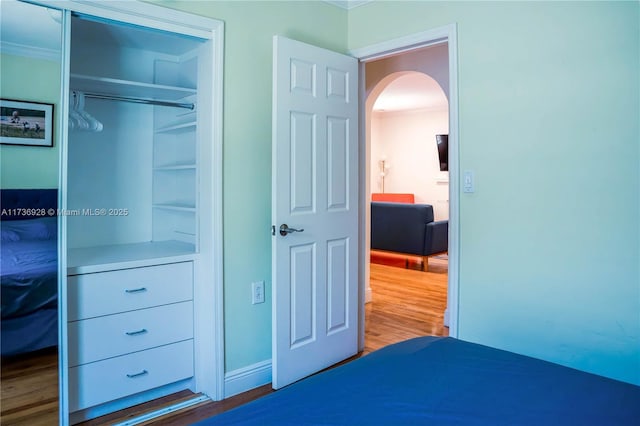 bedroom with hardwood / wood-style flooring and a closet