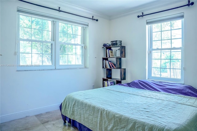 bedroom featuring multiple windows, crown molding, and baseboards