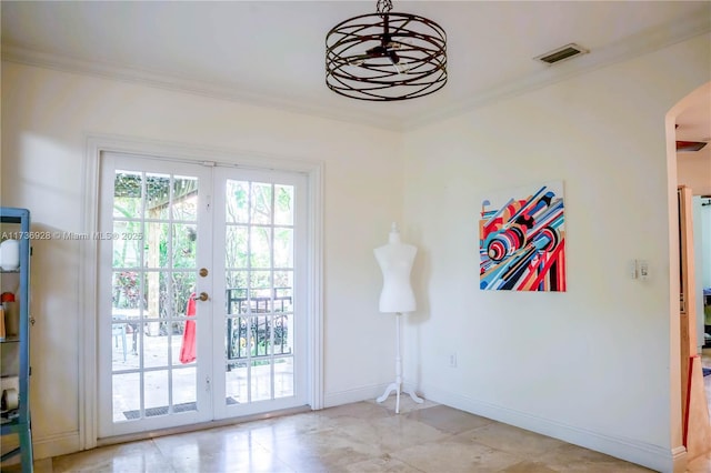 entryway featuring ornamental molding and french doors