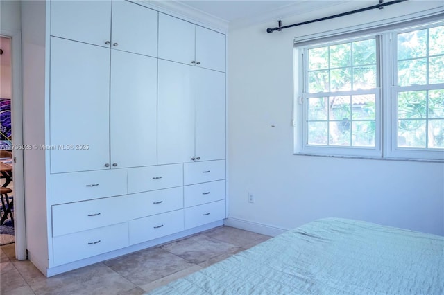 bedroom featuring ornamental molding and a closet