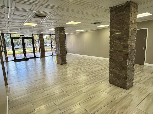 interior space with visible vents, french doors, an ornate ceiling, and baseboards