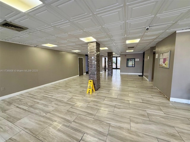 interior space with an ornate ceiling, visible vents, and baseboards