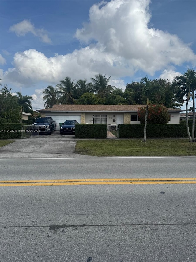 view of front of home featuring a garage and a front yard