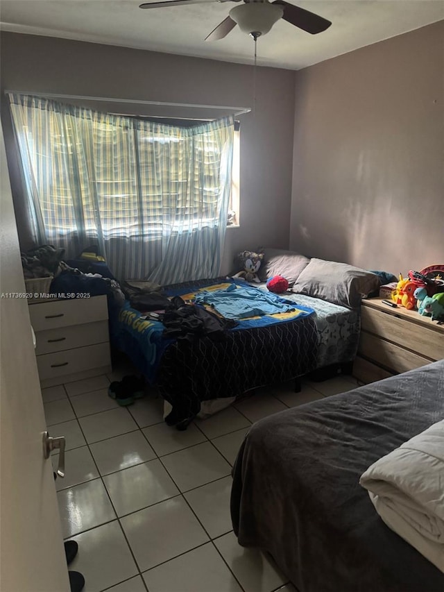 bedroom featuring light tile patterned flooring and ceiling fan