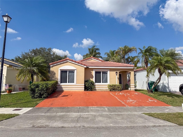 mediterranean / spanish home featuring a front yard