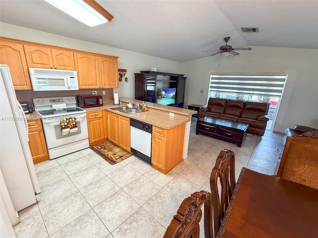 kitchen with light tile patterned flooring, lofted ceiling, sink, kitchen peninsula, and white appliances