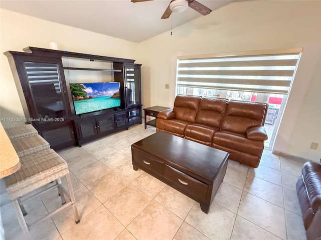 tiled living room with ceiling fan and vaulted ceiling