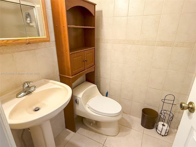 bathroom featuring tile walls, sink, tile patterned floors, and toilet