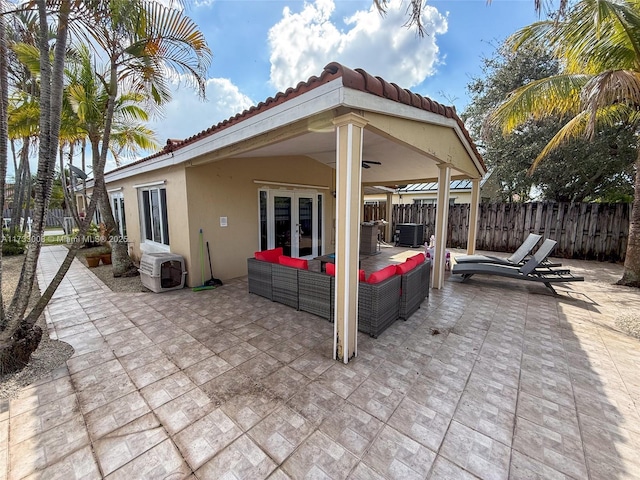 view of patio / terrace featuring central AC unit, an outdoor hangout area, french doors, and ceiling fan