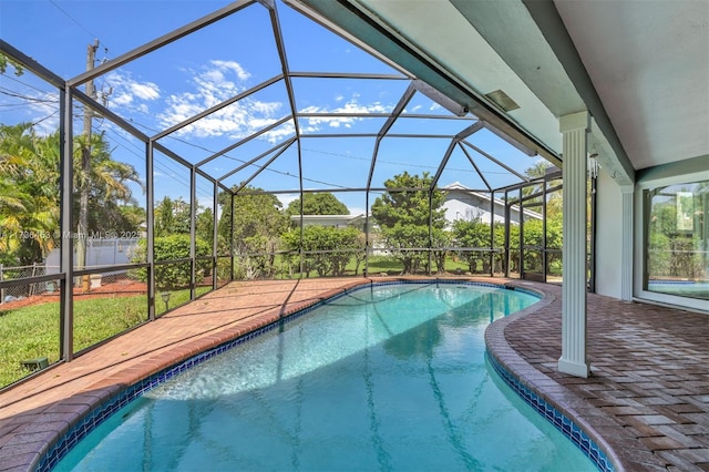 view of swimming pool featuring glass enclosure