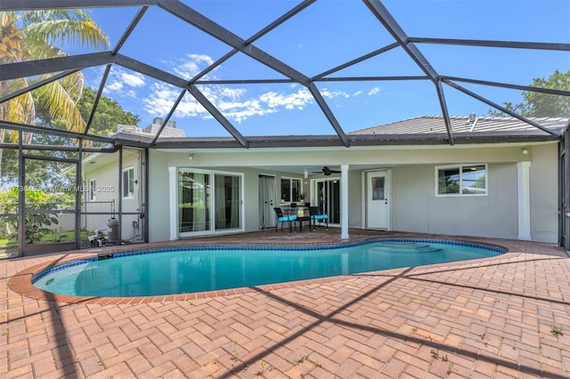 view of pool featuring a patio, ceiling fan, and glass enclosure