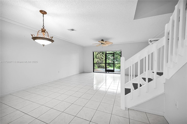 interior space featuring ornamental molding, light tile patterned floors, a textured ceiling, and ceiling fan