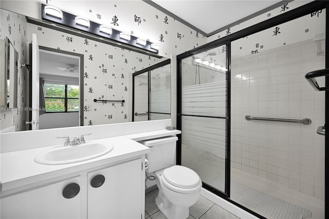 bathroom with vanity, a shower with shower door, and toilet