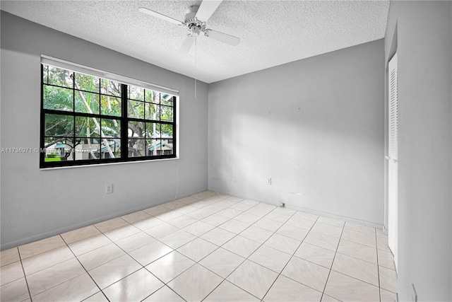 spare room with ceiling fan and a textured ceiling