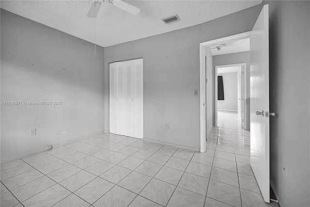 spare room with a textured ceiling and ceiling fan