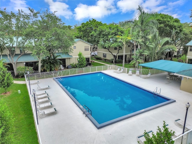 view of pool featuring a patio and a lawn