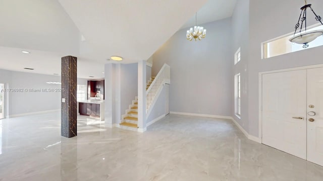 entrance foyer featuring an inviting chandelier and a towering ceiling