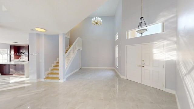 foyer featuring a towering ceiling