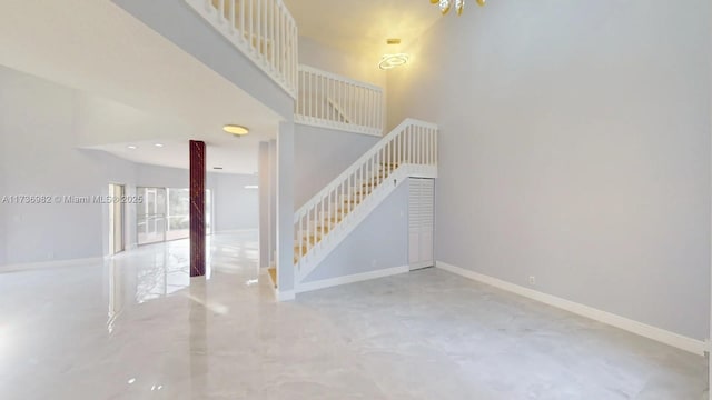 stairs featuring a high ceiling