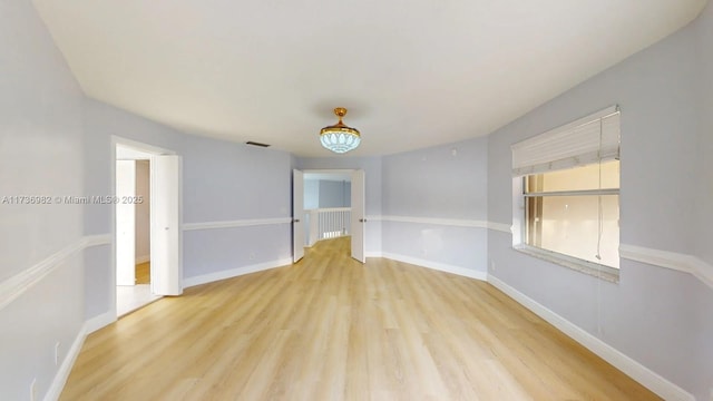 spare room featuring light hardwood / wood-style floors