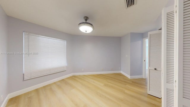 unfurnished bedroom with light hardwood / wood-style floors and a closet