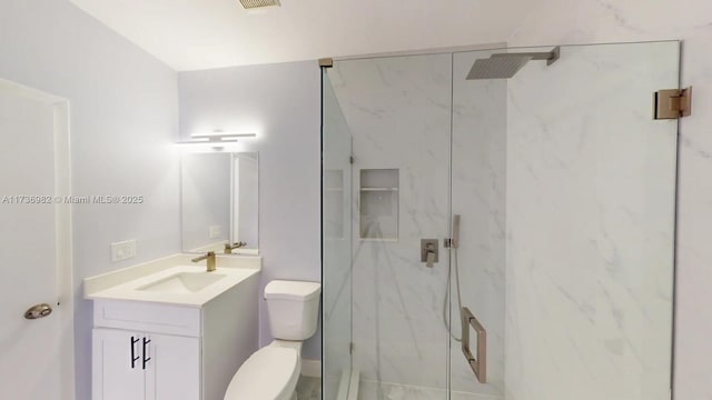 bathroom with vanity, an enclosed shower, and toilet