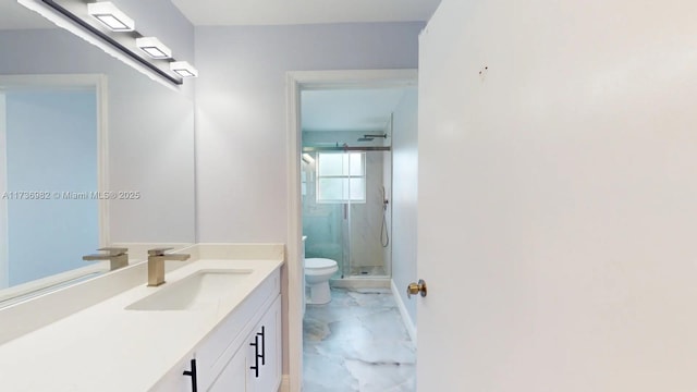 bathroom featuring vanity, a shower with door, and toilet