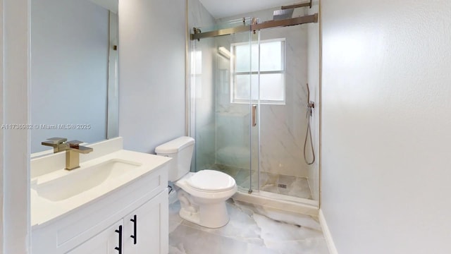 bathroom with vanity, toilet, and a shower with shower door