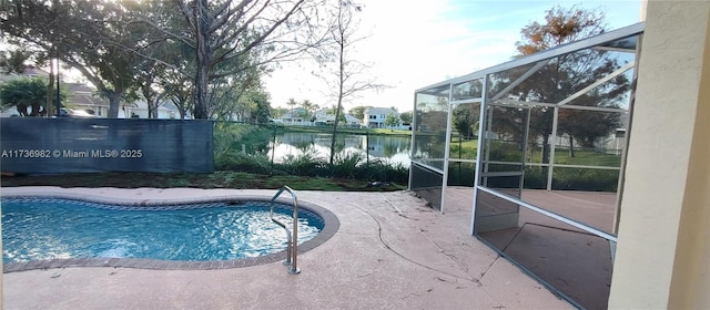 view of swimming pool featuring a water view, a lanai, and a patio area