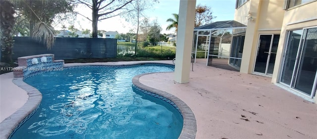 view of pool featuring a patio and glass enclosure