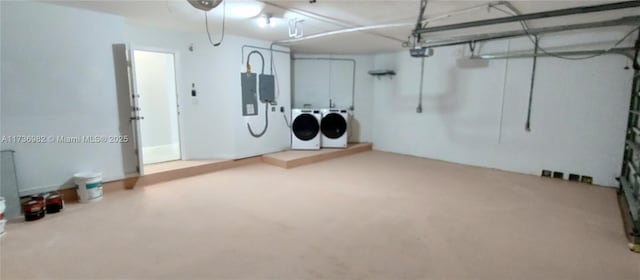 basement with electric panel and washer and dryer