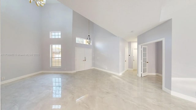 foyer entrance featuring high vaulted ceiling