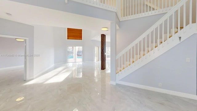 foyer entrance with a towering ceiling