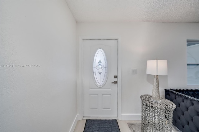 entryway with a textured ceiling